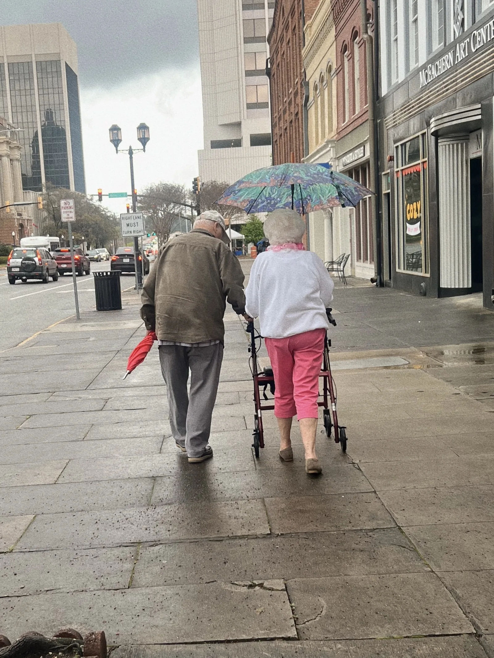 A couple walking together under an umbrella