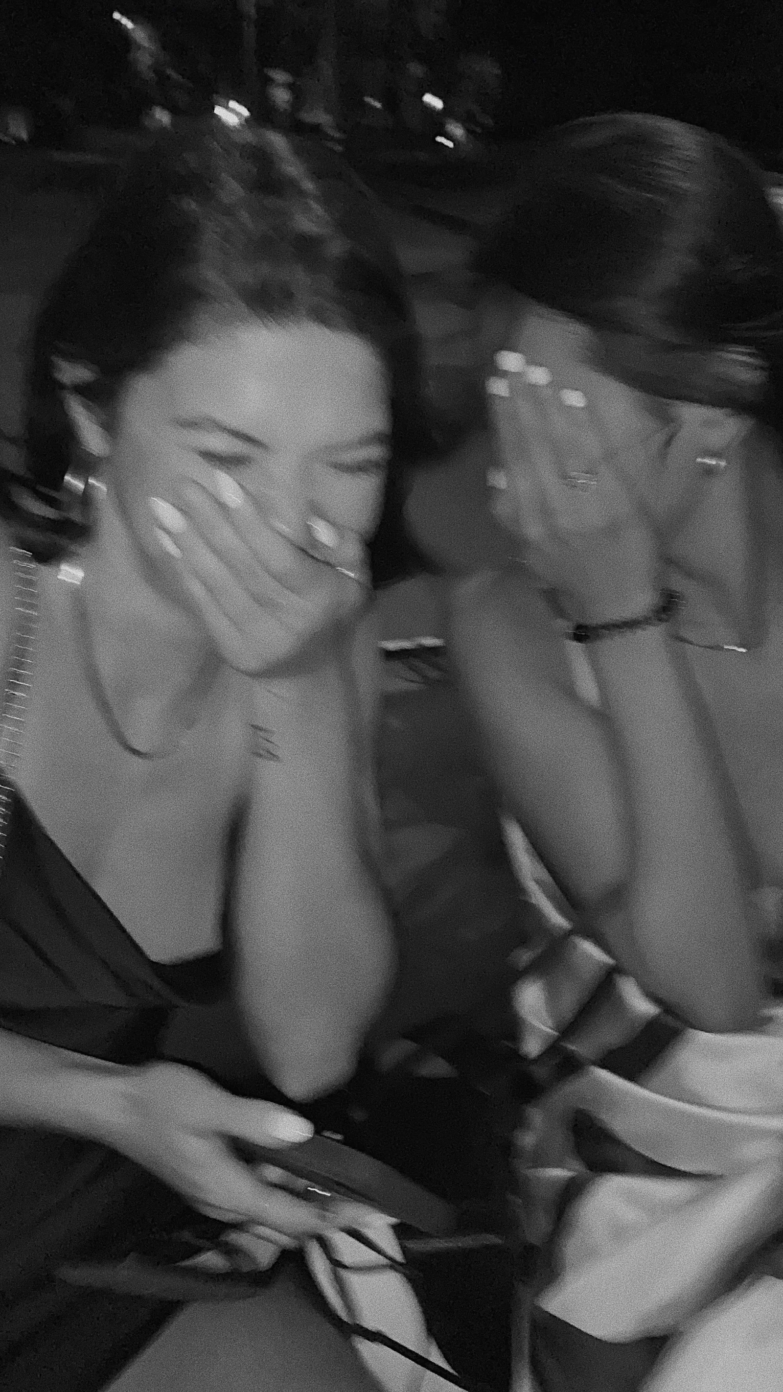 Two friends laughing in a black and white photograph