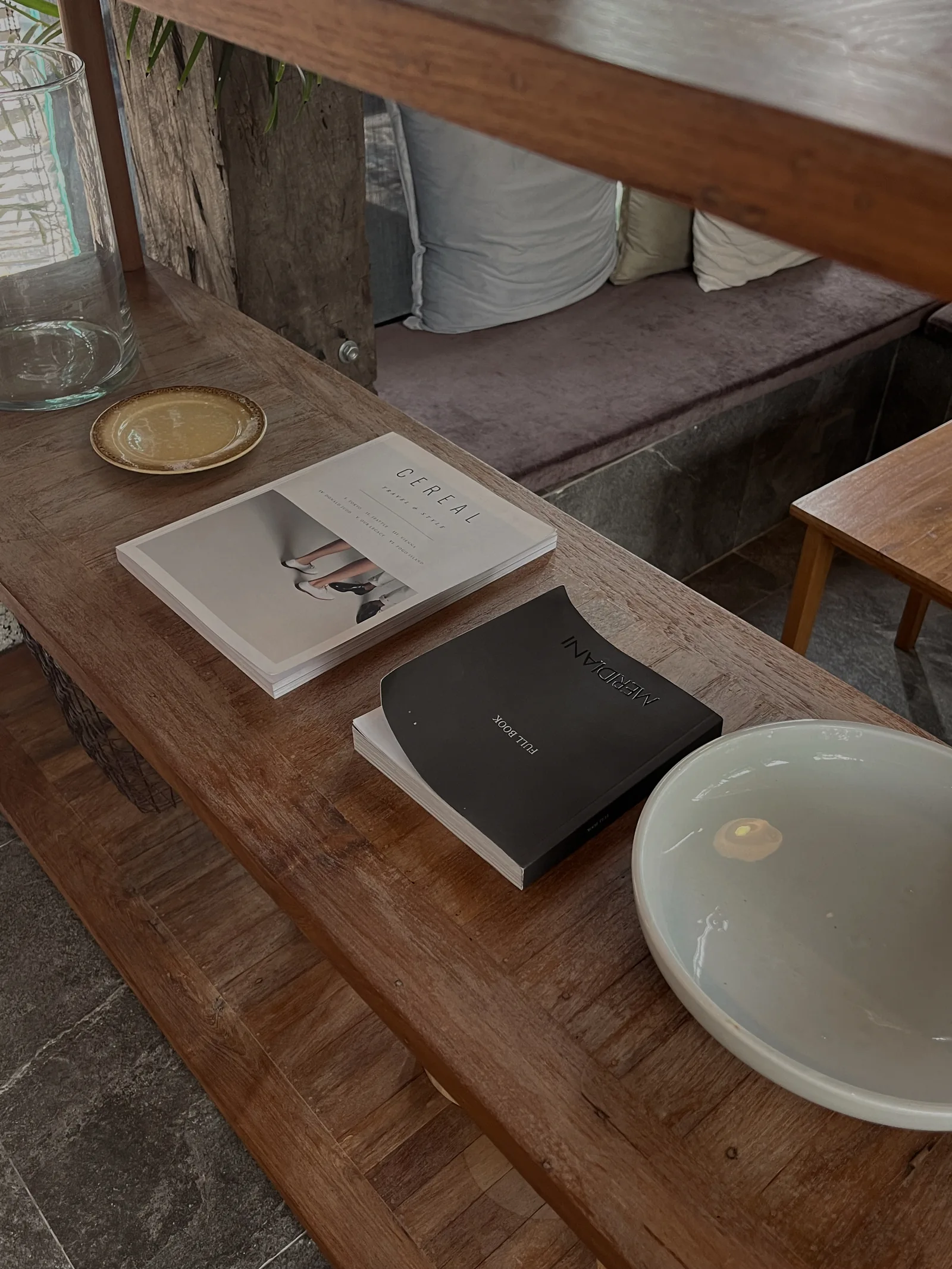 Books on a coffee table beside a chair