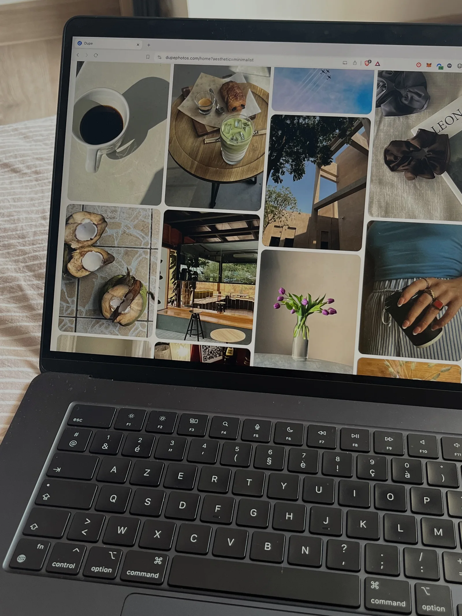 A laptop displaying a grid of photographs