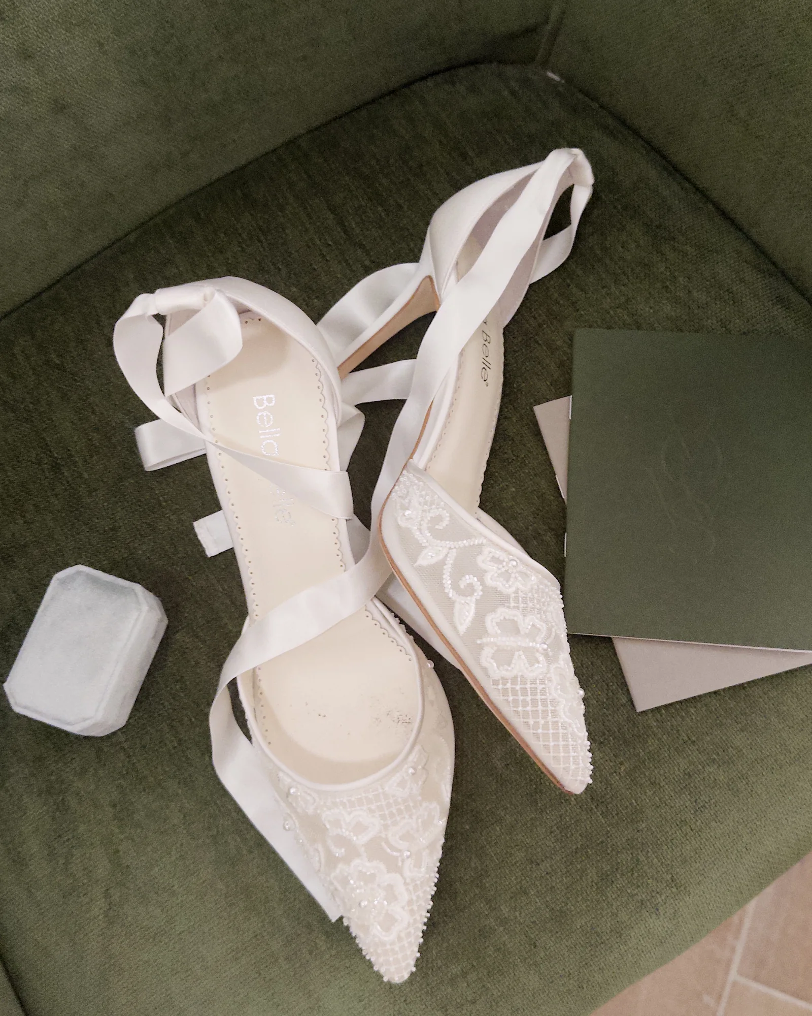 White shoes resting on a green chair