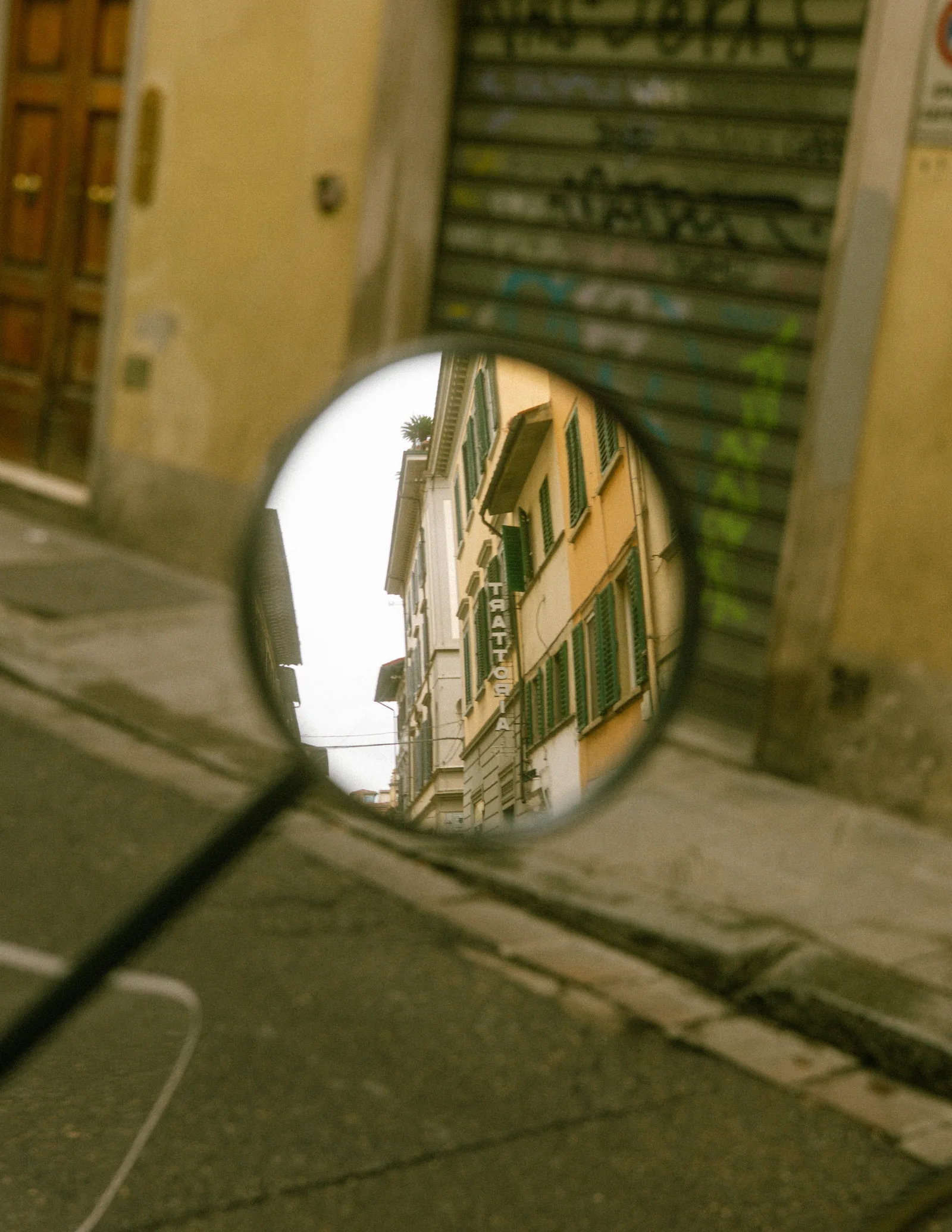 A street reflected in a round mirror