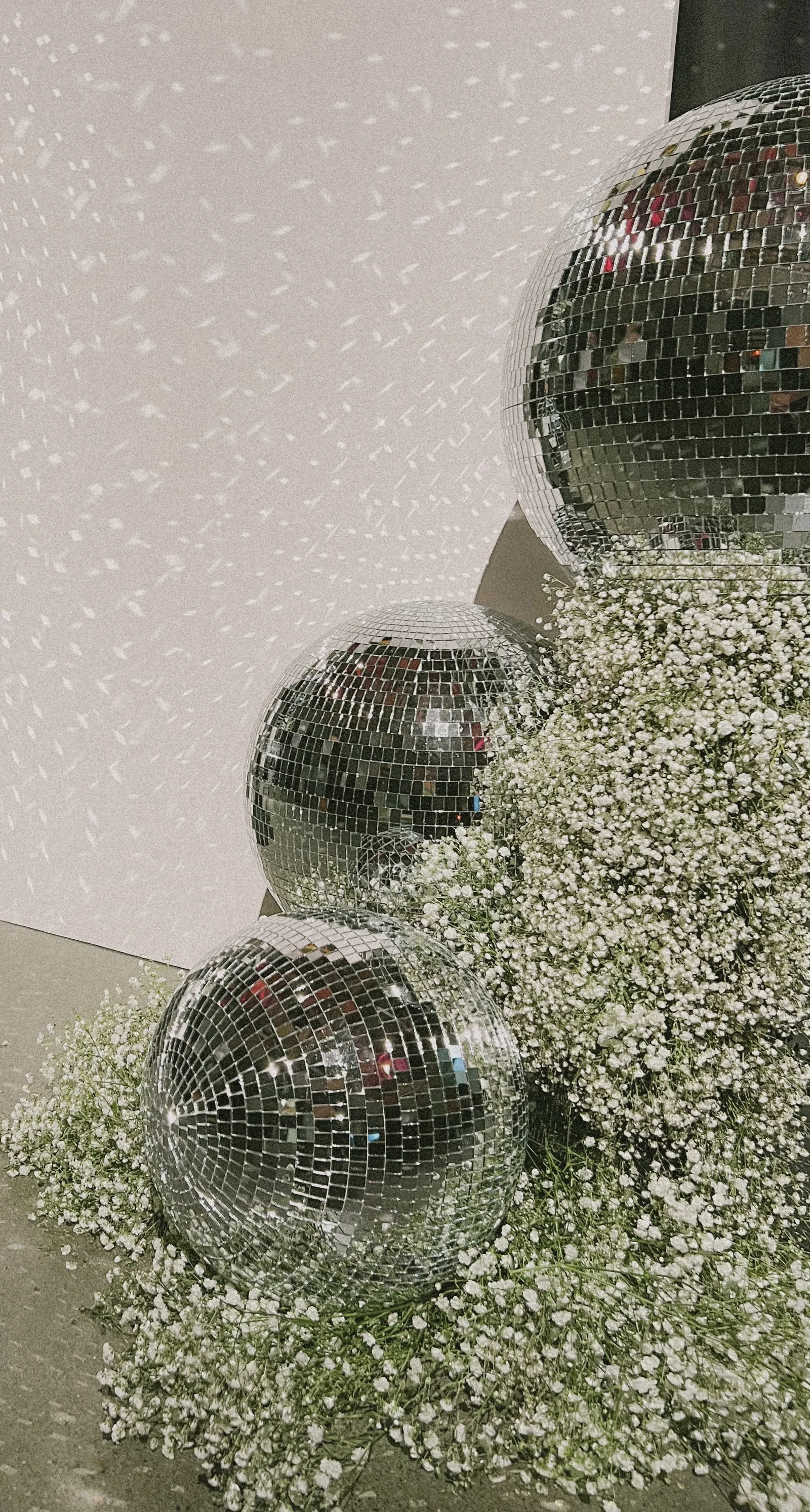 Disco balls and white flowers at a celebration