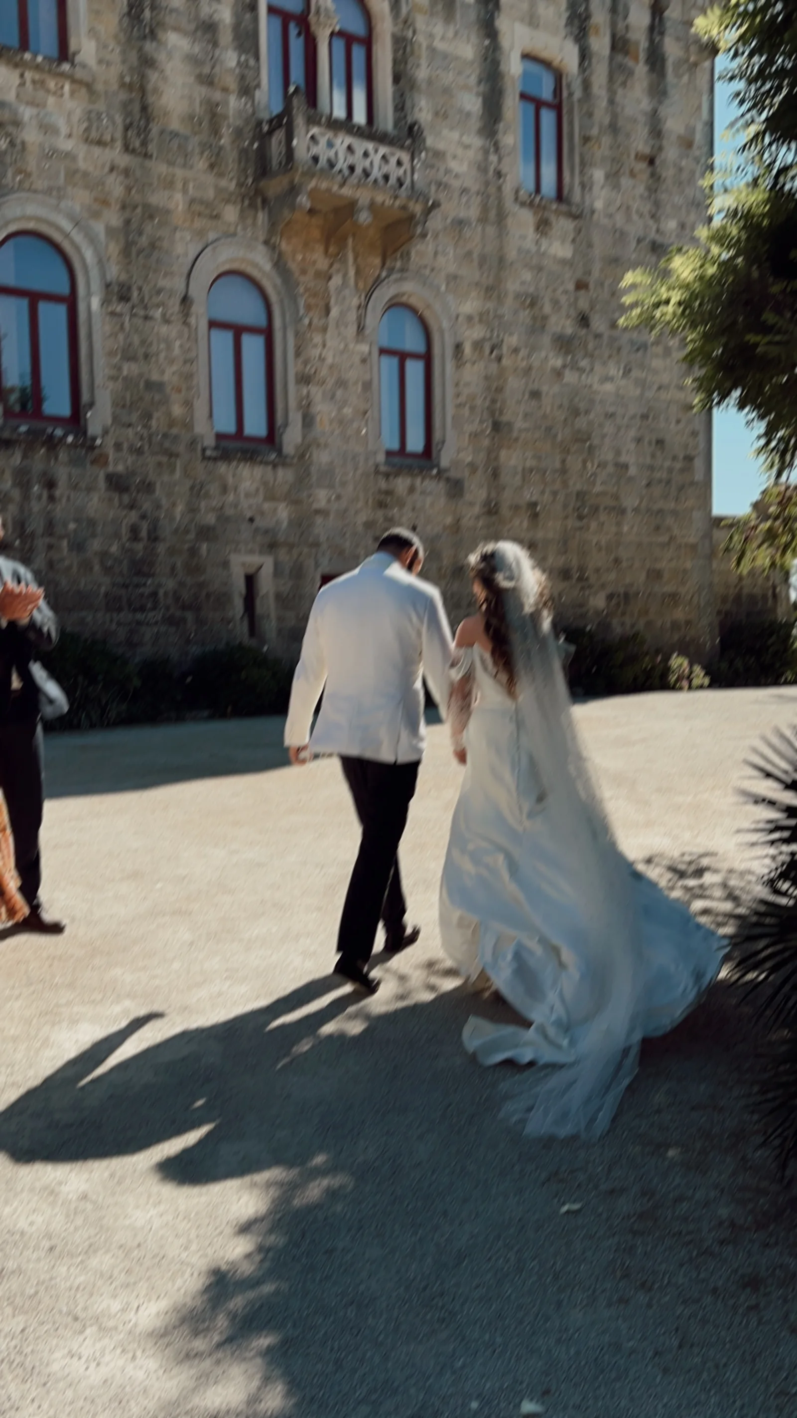 A newly married couple walking together in sunshine